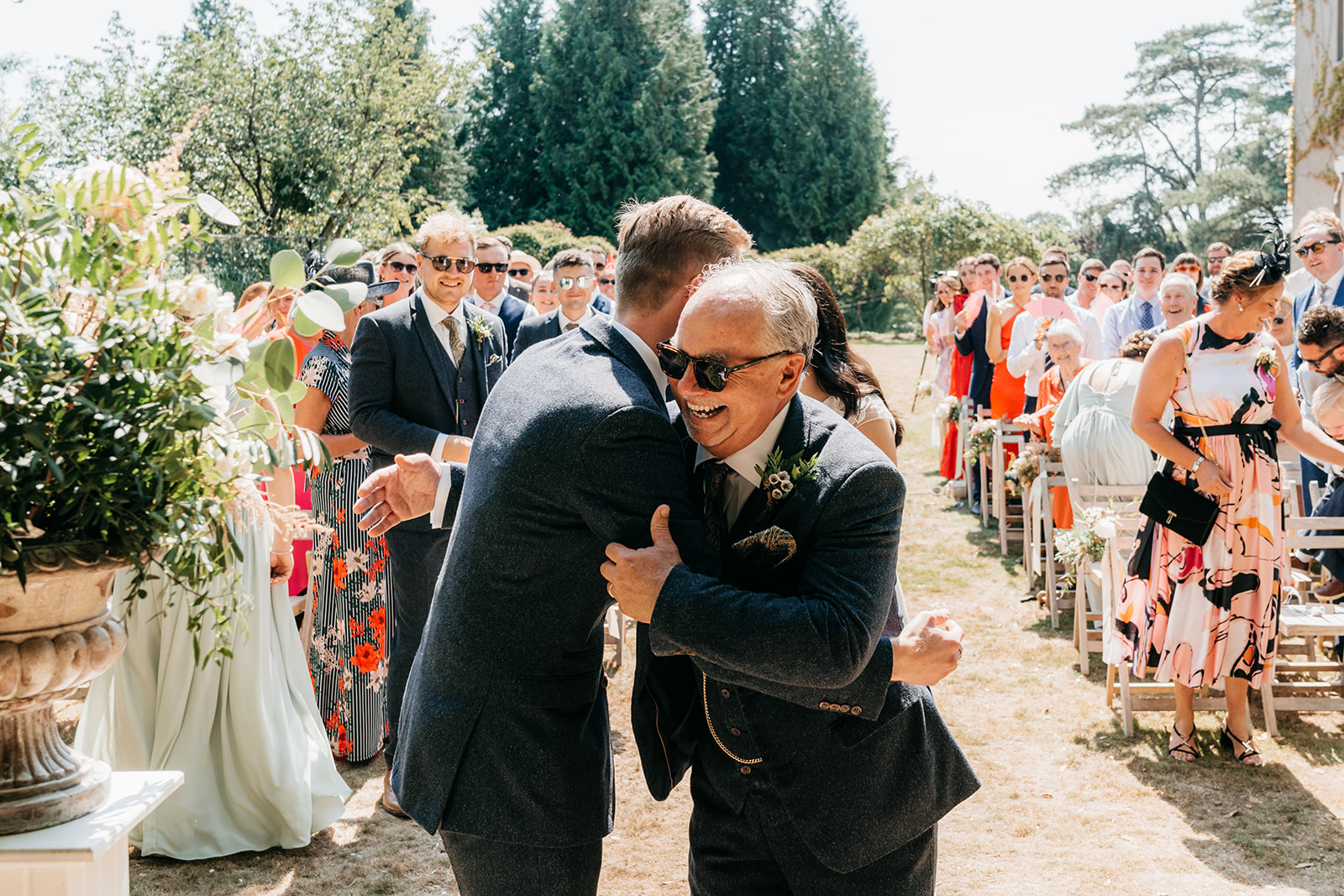The brides father giving the groom a hug before giving his daughter away 