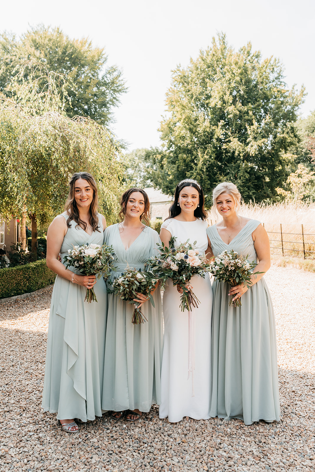 The bridesmaids and bride looking beautiful in their gowns