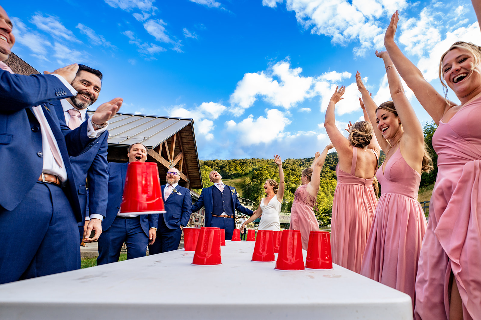 bridesmaids and groomsmen playing drinking games
