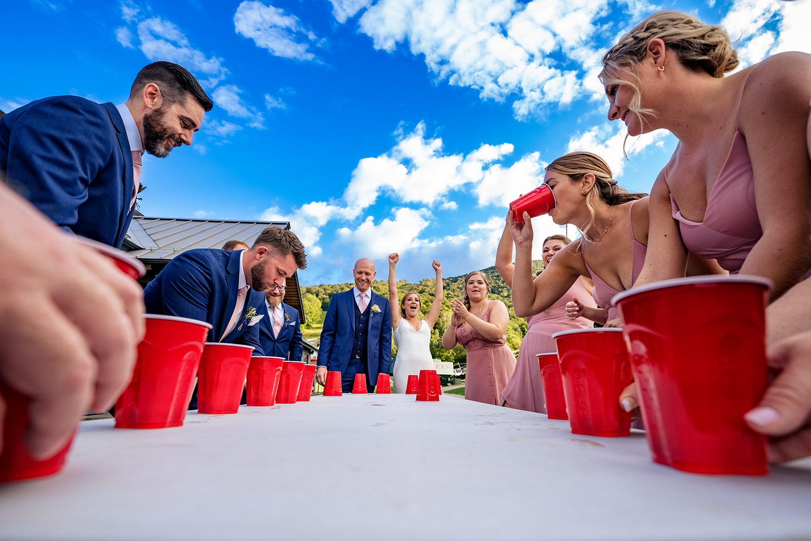 fun photos of wedding party playing flip cup