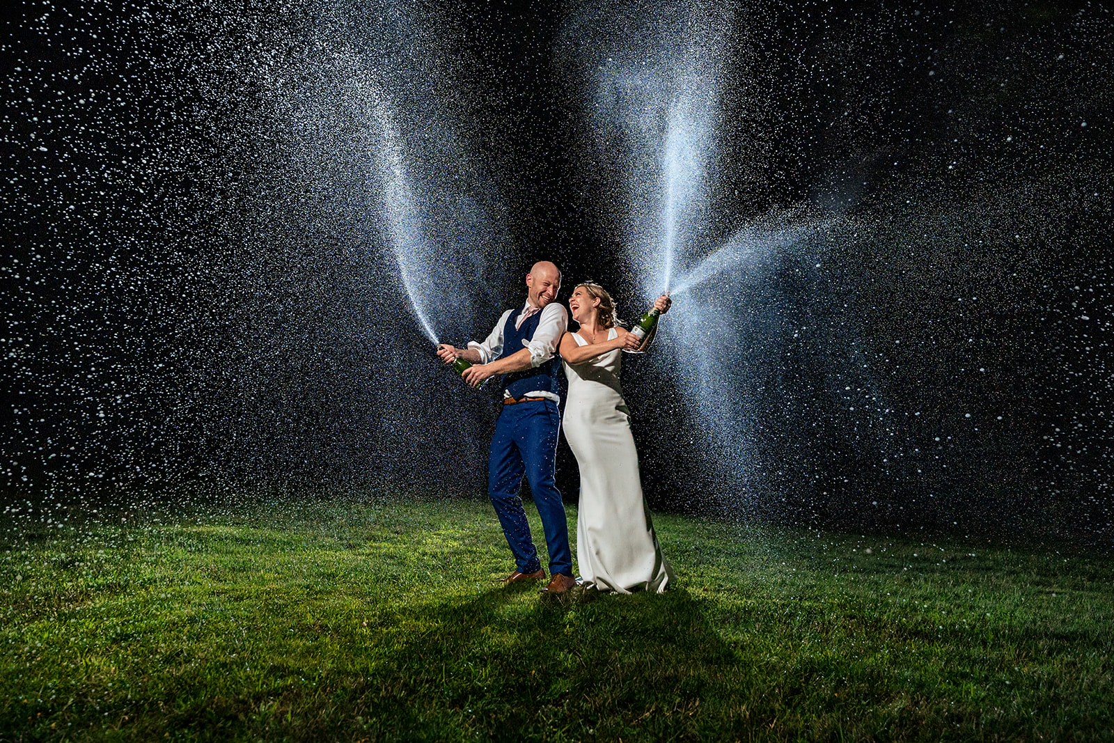 bride and groom champagne spray photo at vermont wedding