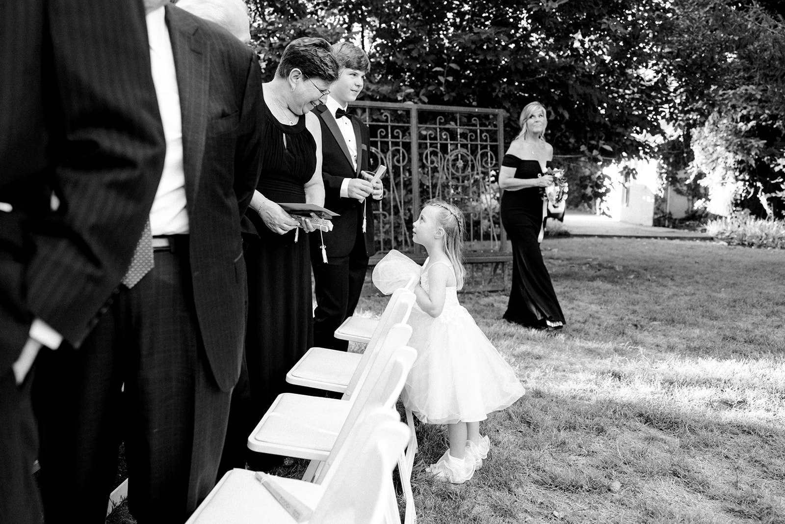 black and white kid at wedding talking to adult