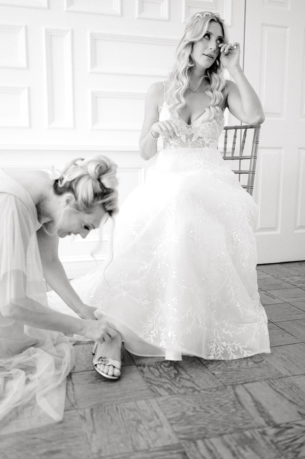emotional bride with mom putting on shoes 