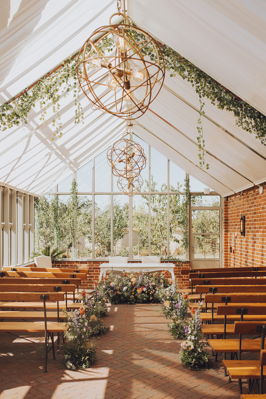 Summer glasshouse wedding at Syrencot with colourful floral decor