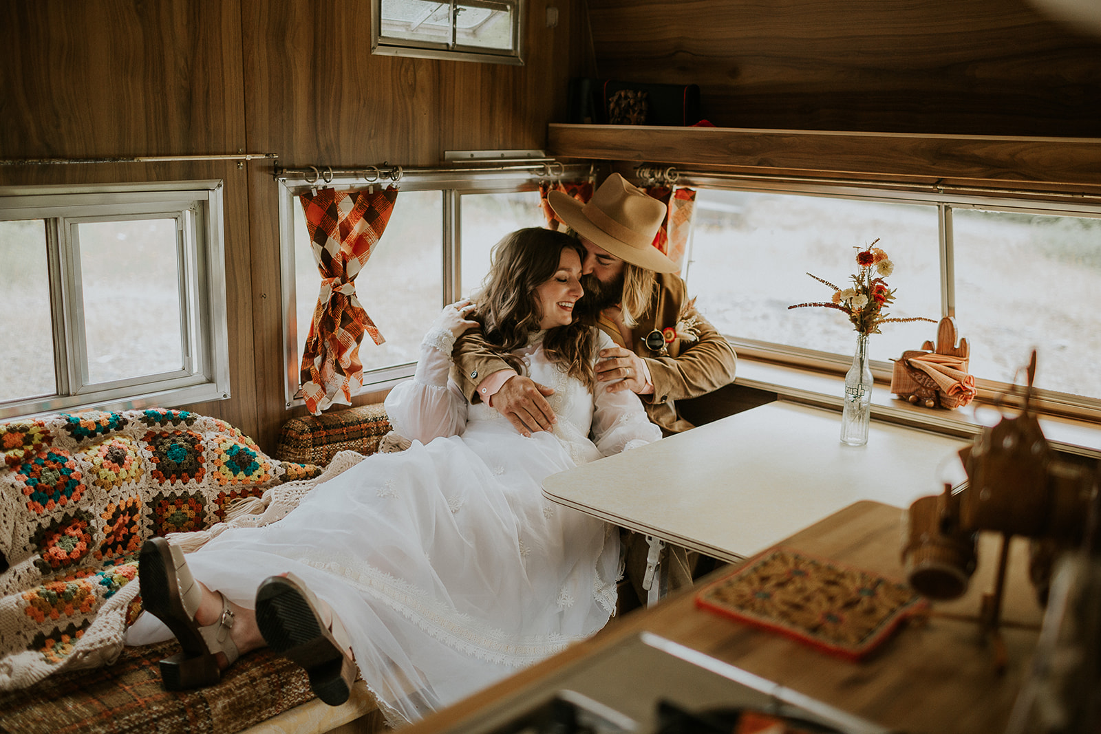 bride and groom in retro camper