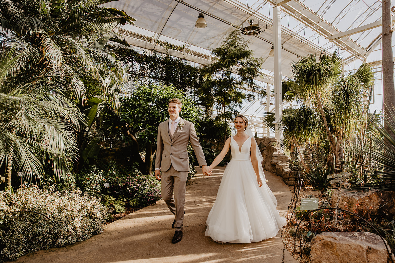 Bride and groom arriving at the reception at a RHS Gardens Wisley Wedding. By Olive Joy Photography