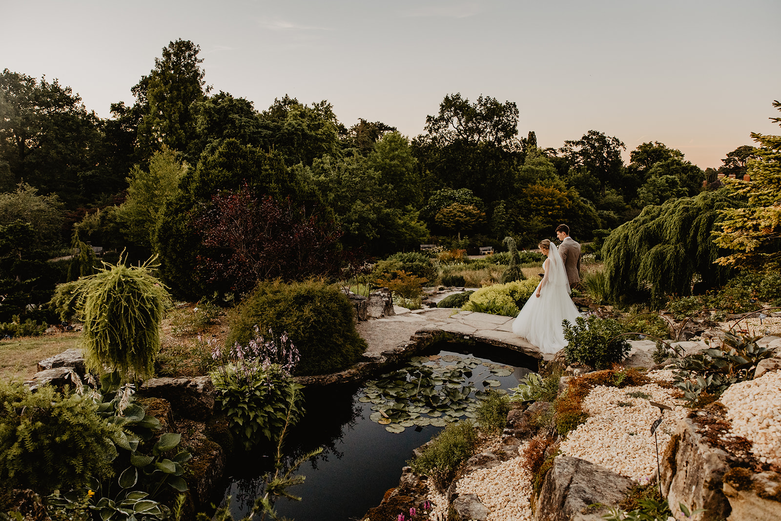 Bride and groom during golden hour at a RHS Gardens Wisley Wedding. By Olive Joy Photography