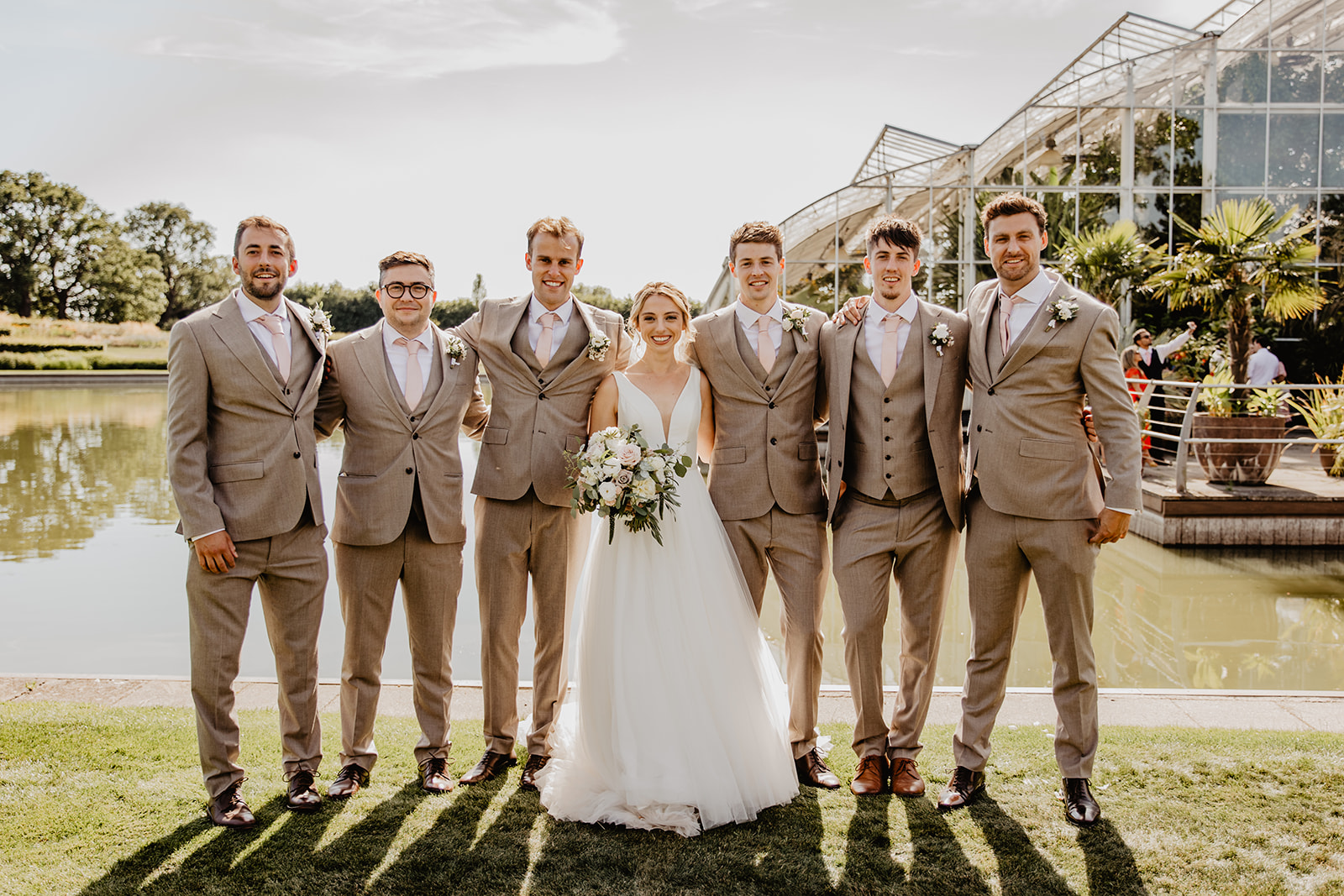 Bride, groom and groomsmen at a RHS Gardens Wisley Wedding. By Olive Joy Photography