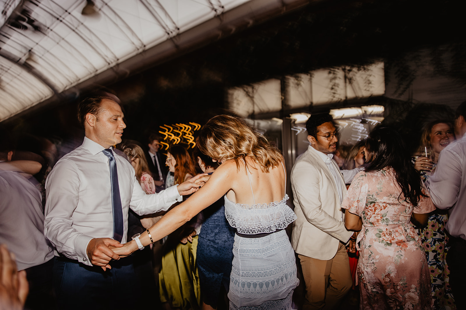 Guests dancing at a RHS Gardens Wisley Wedding. By Olive Joy Photography