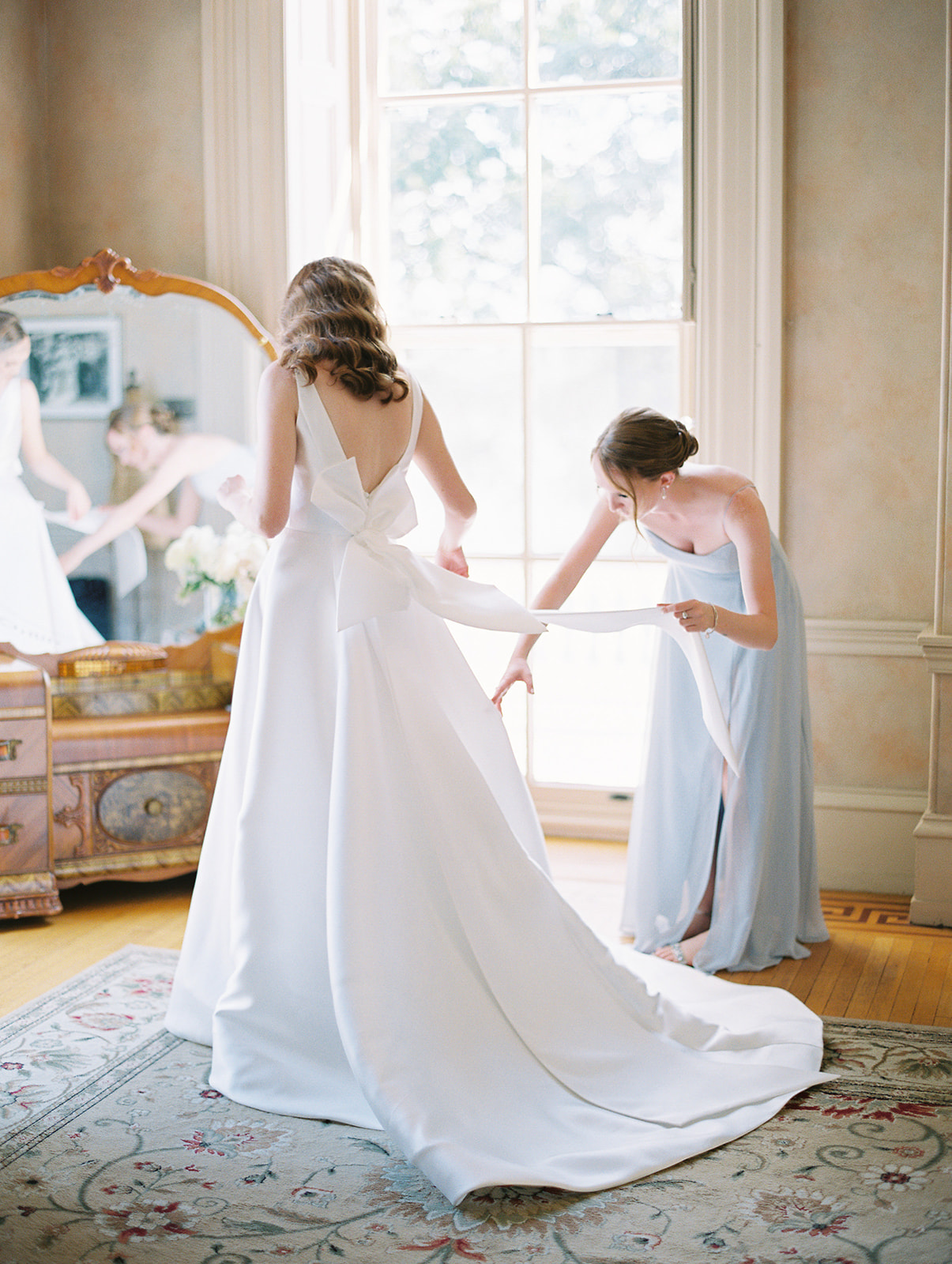 intimate moment of bride getting dressed at Timeless Garden Wedding at Historic Glen Foerd Estate in Philadelphia, PA
