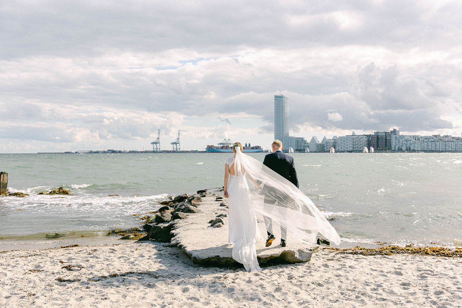 Stunning Aarhus beach wedding photo featuring happy couple