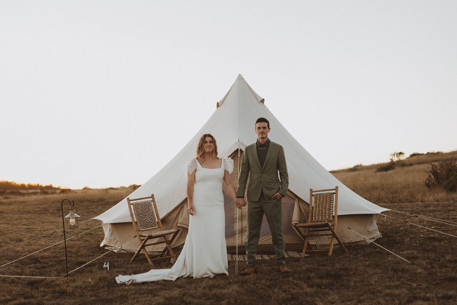 Bride and groom portrait with glamping tent