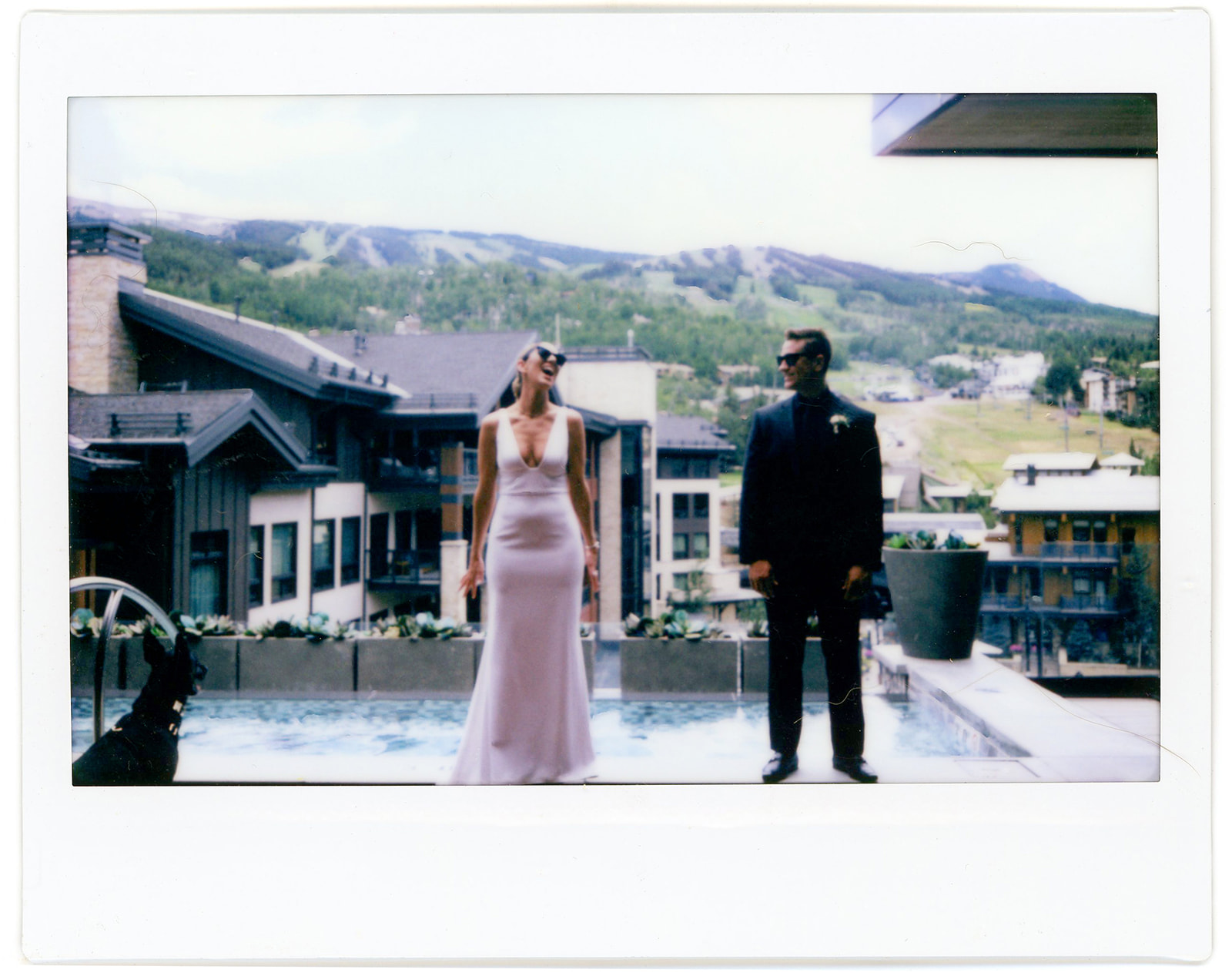 A bride and groom on top of limelight hotel pool 