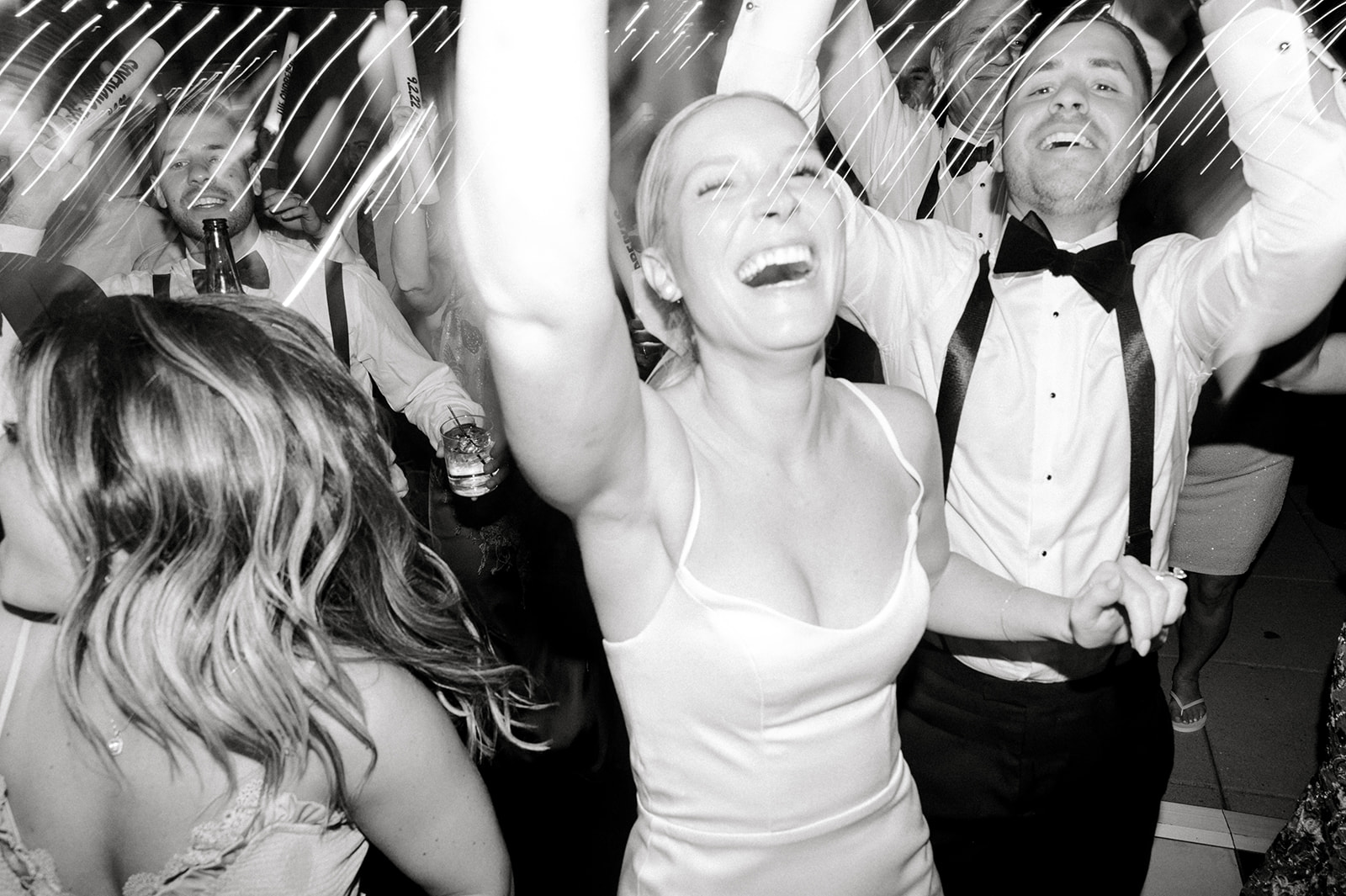 black and white photo of bride happily dancing during wedding reception at the free library of philadelphia 