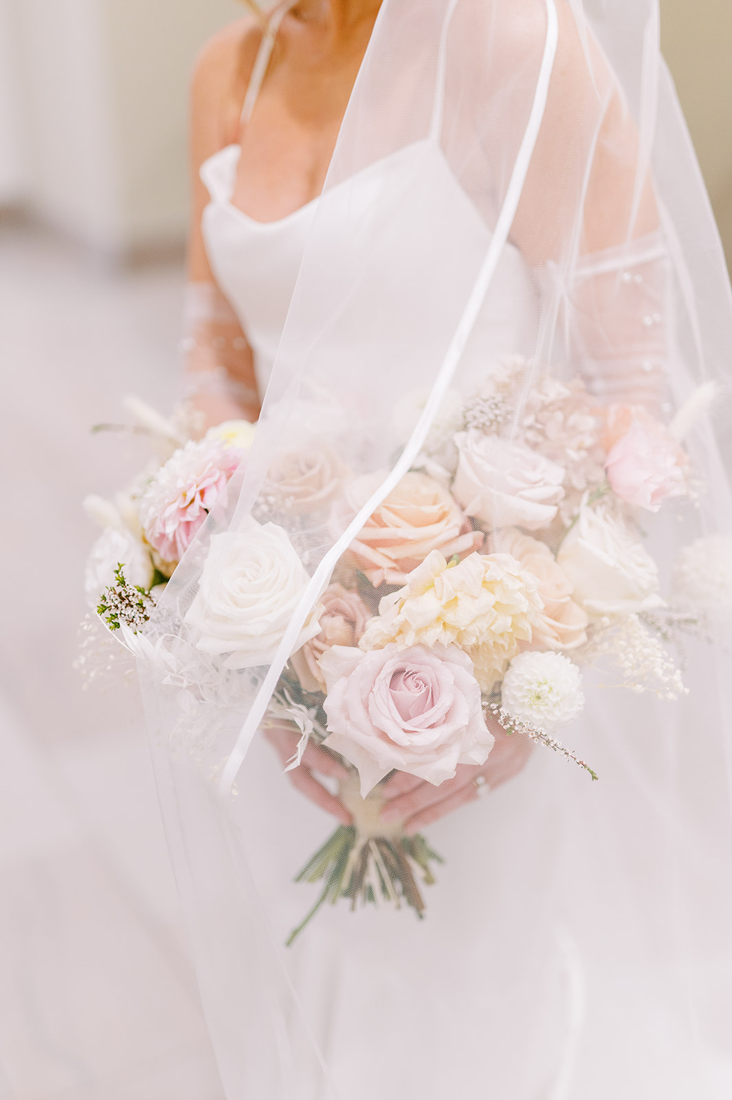 chic monochrome wedding bouquet in whites under bridal veil