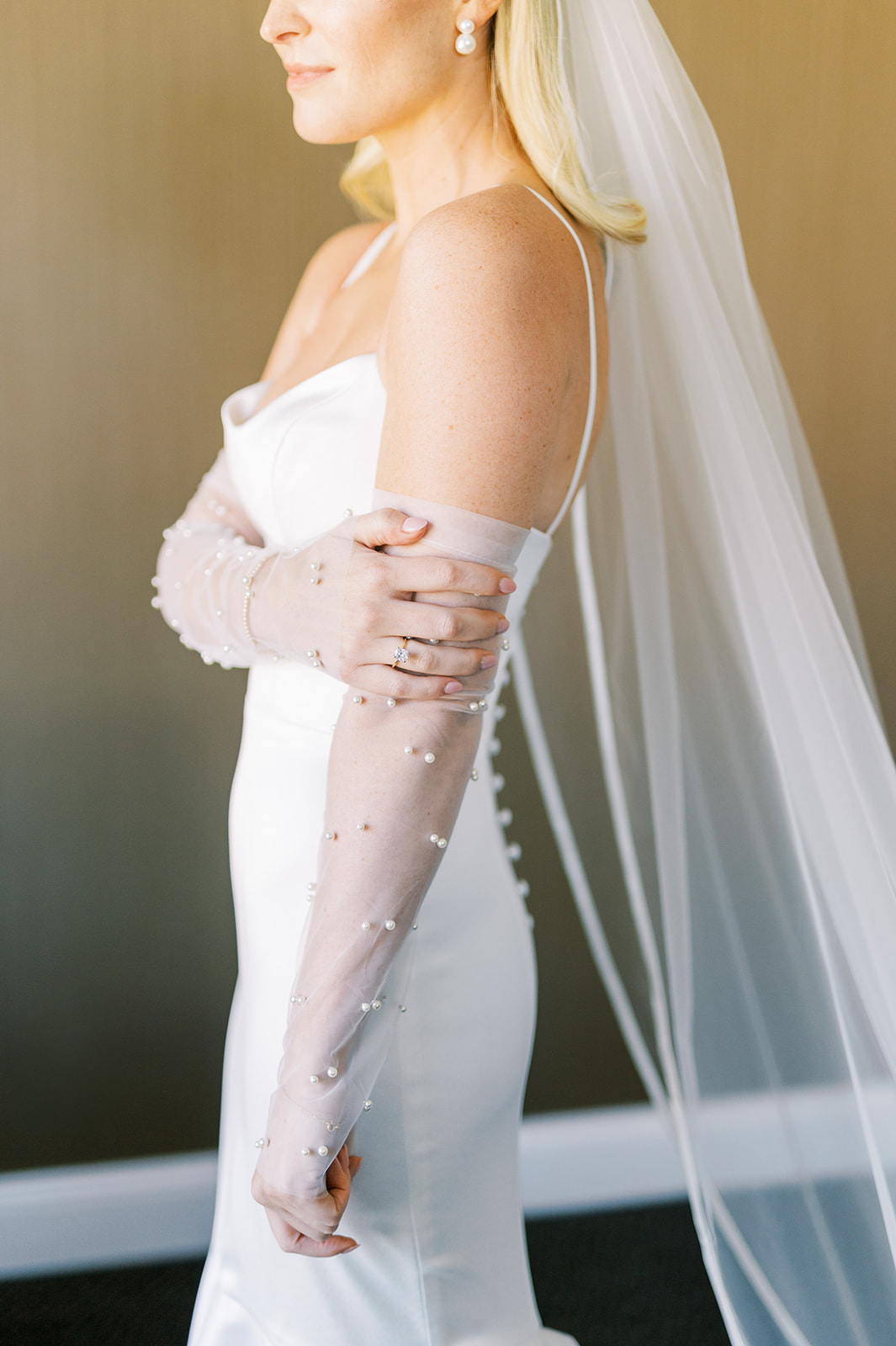 sheer white gloves with pearl accents on chic bride in sleek white gown at The Logan in Philadelphia, PA