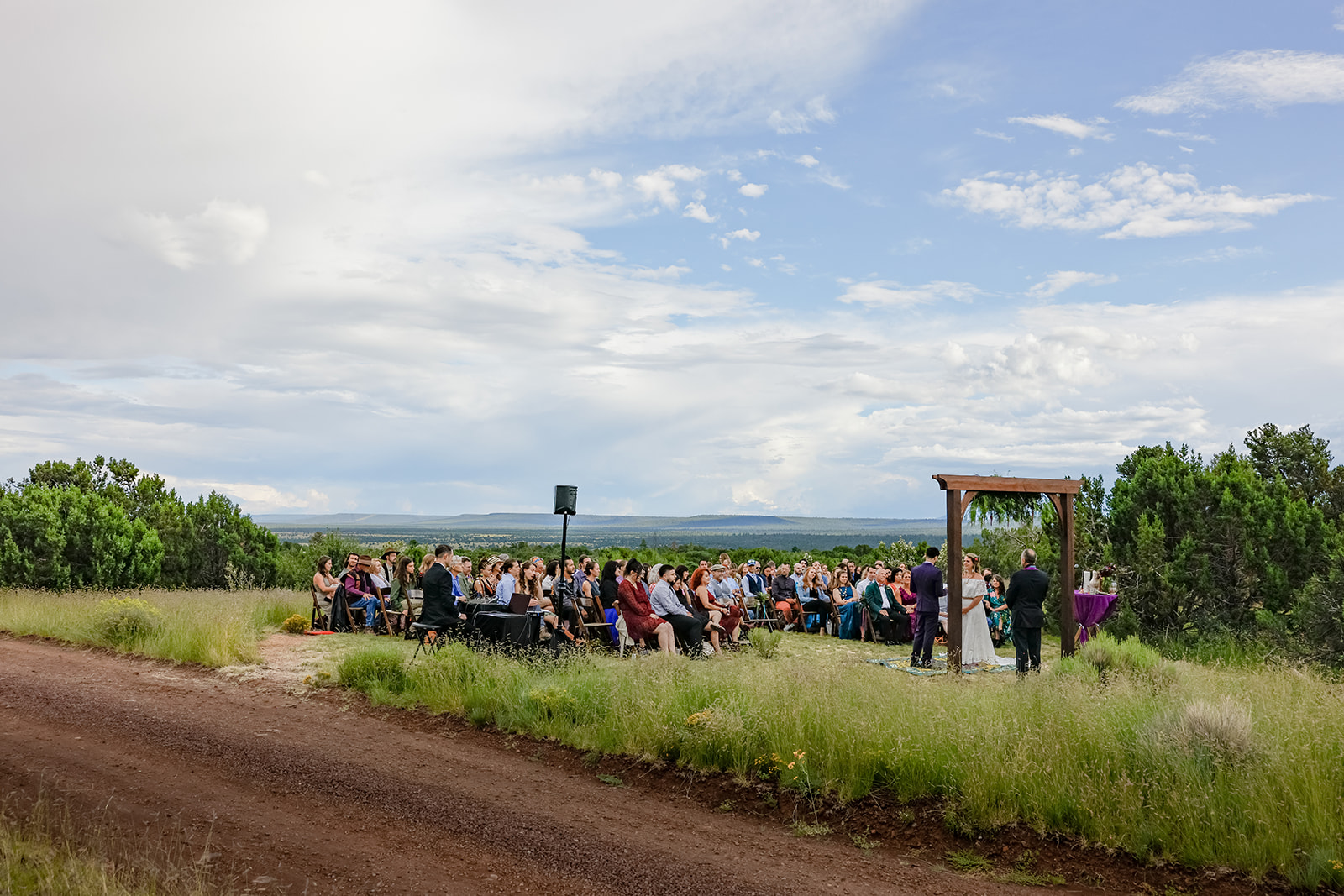 Big outdoor Flagstaff summer wedding with romantic sweeping views by luxury wedding photographers, Heather Kadar