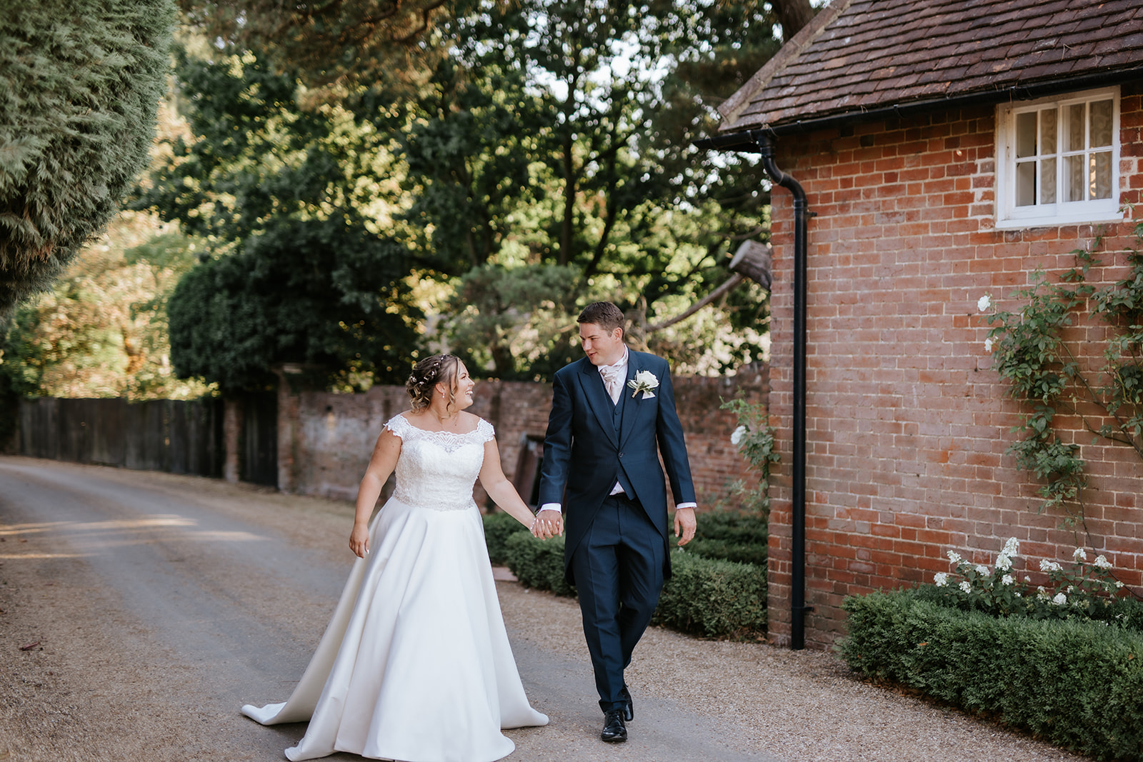 Married couple walking through Gaynes Park wedding venue in Essex