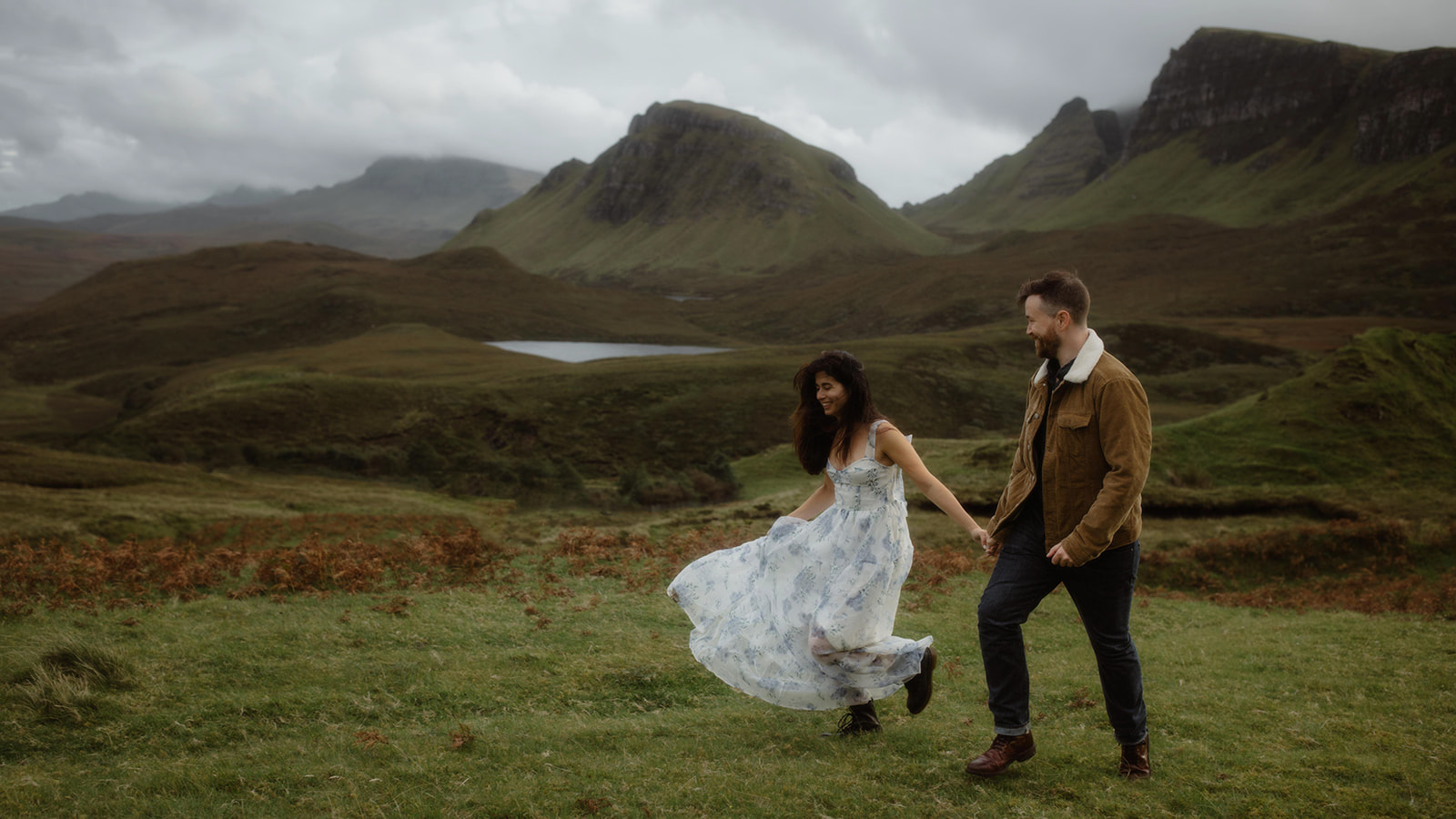 Alex and Elliot walk hand in hand as they stroll around the majestic Isle of Skye during their Adventure Session