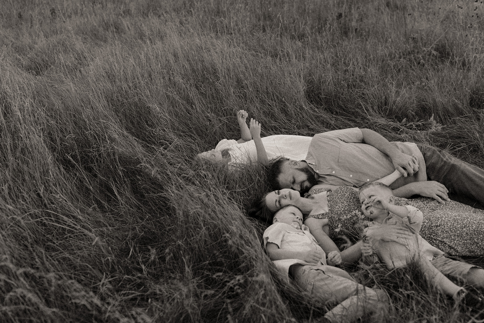 Family laying in grass