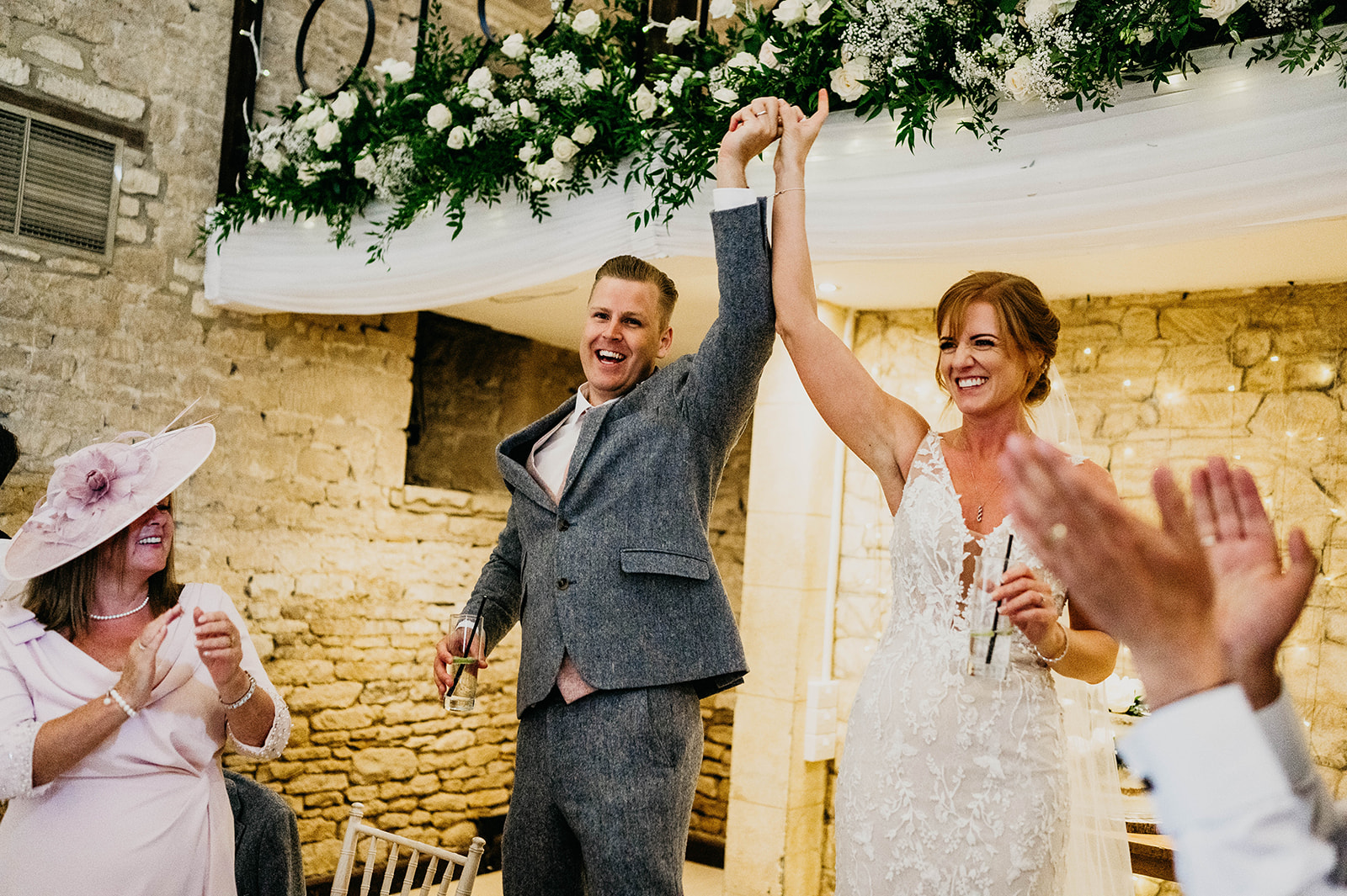 Bride and groom arrive for wedding reception at The Great Tythe Barn, Tetbury