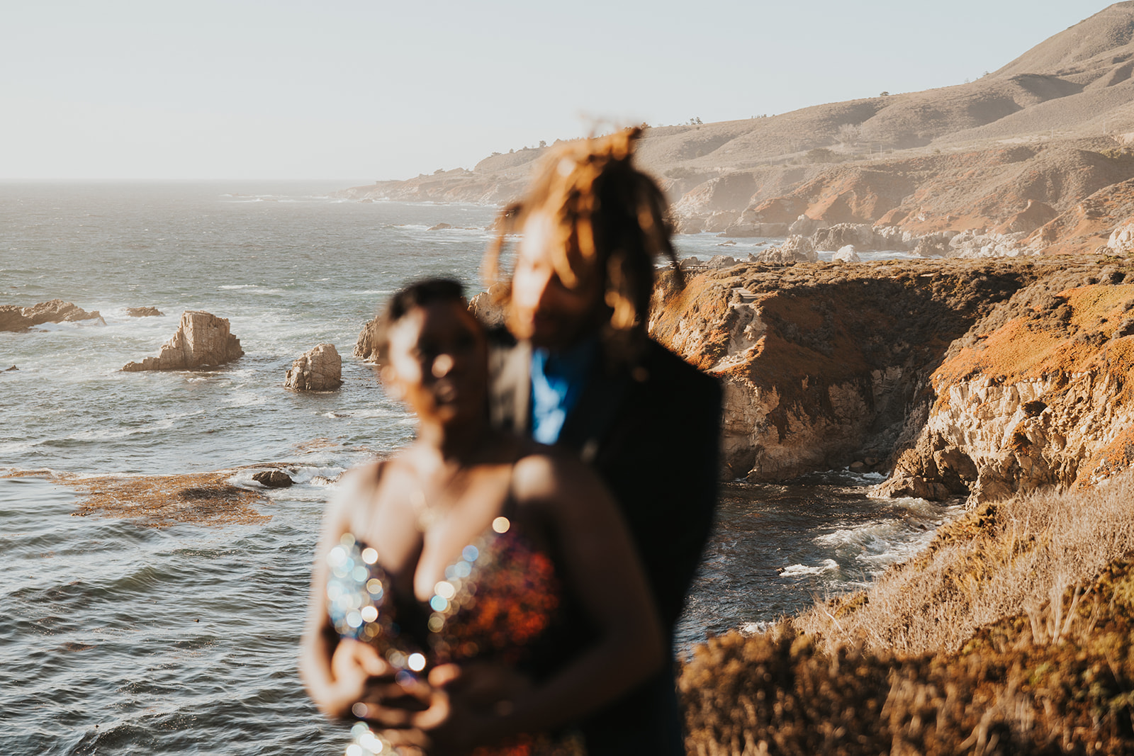 Big Sur background with couple out of focus in front