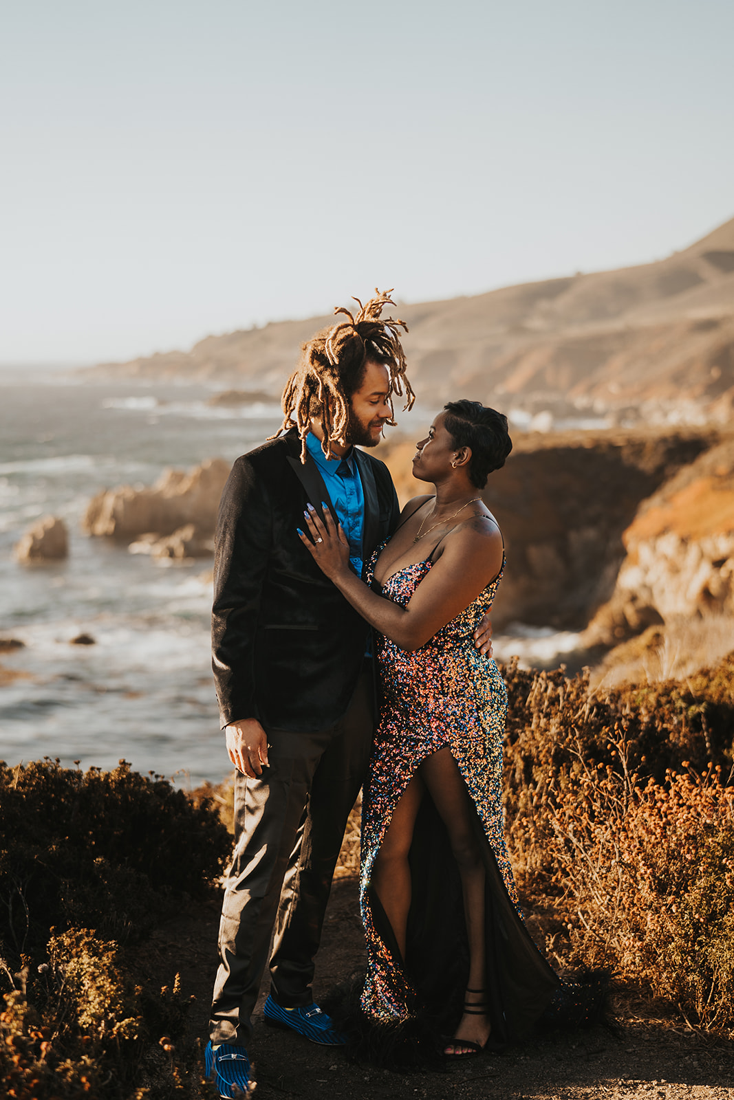 Posed couple stands beautifully against Big Sur coastline