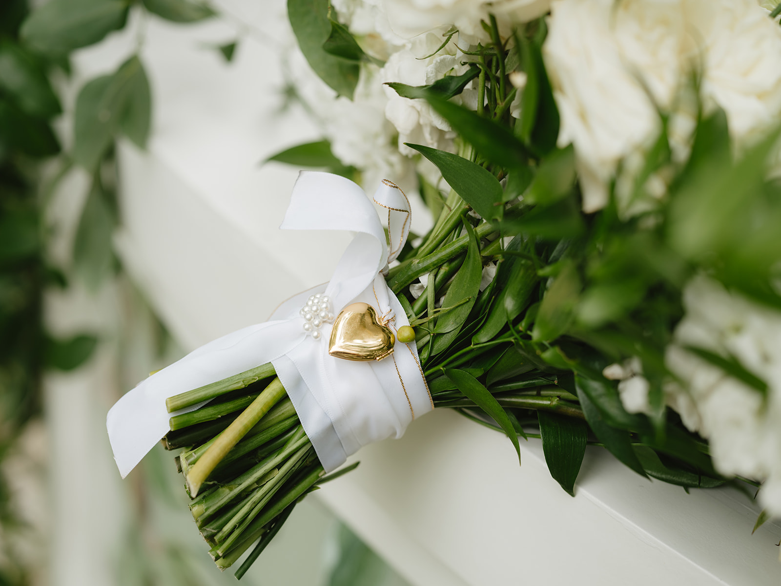 locket on bridal bouquet by silks a bloom
