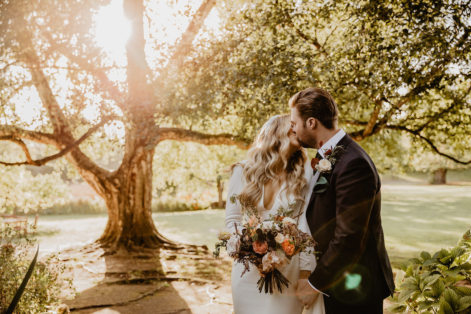 Bride and Groom in gardens at a Hampton Court House Wedding. By Olive Joy Photography