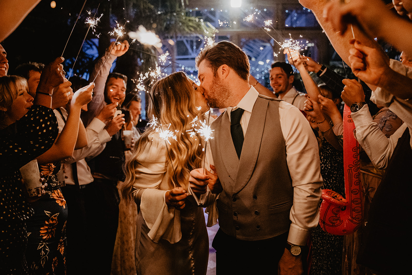 Bride and Groom walk through sparklers at Hampton Court House on their Wedding Day. By Olive Joy Photography