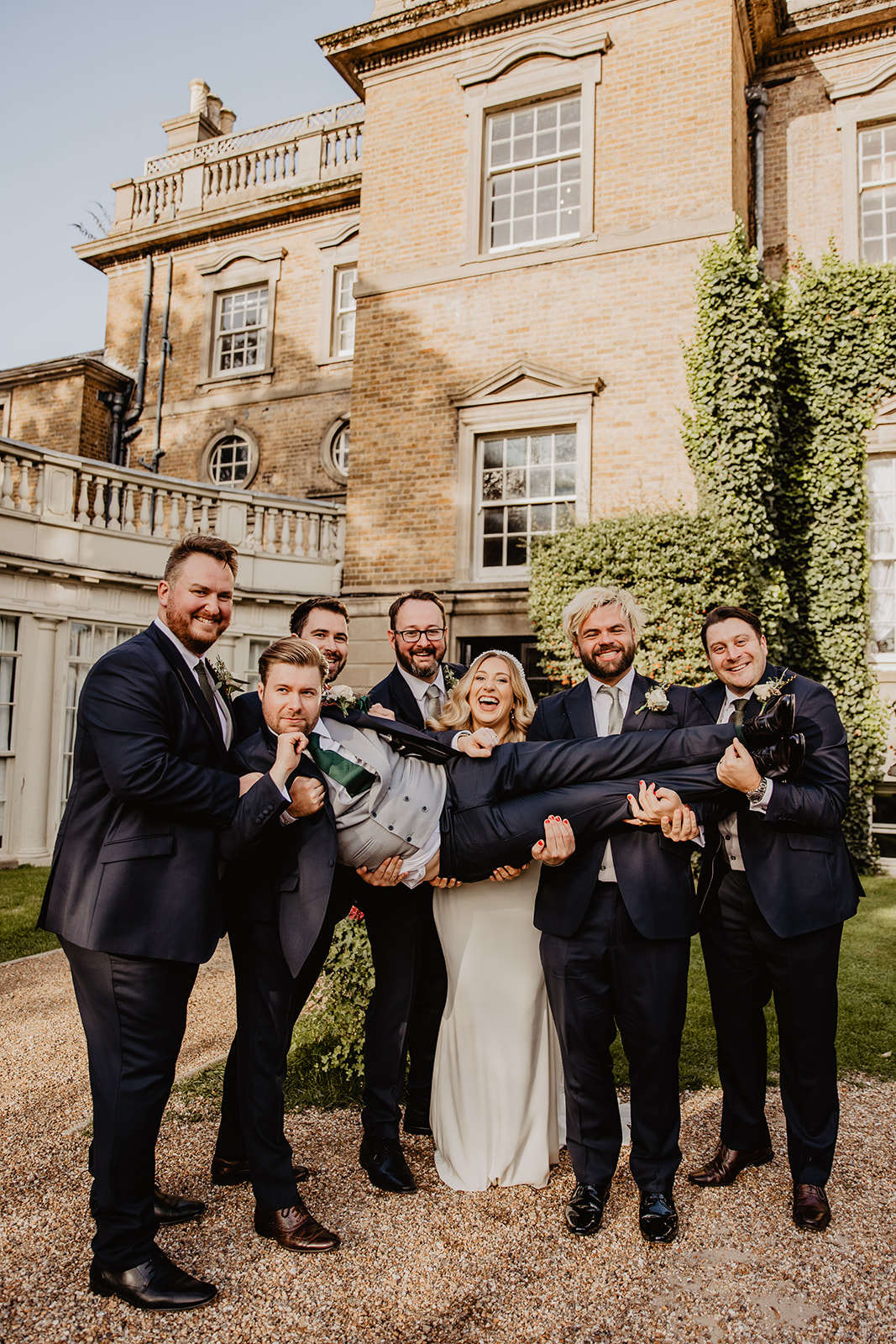Bride, groom and wedding party at a Hampton Court House Wedding. By Olive Joy Photography