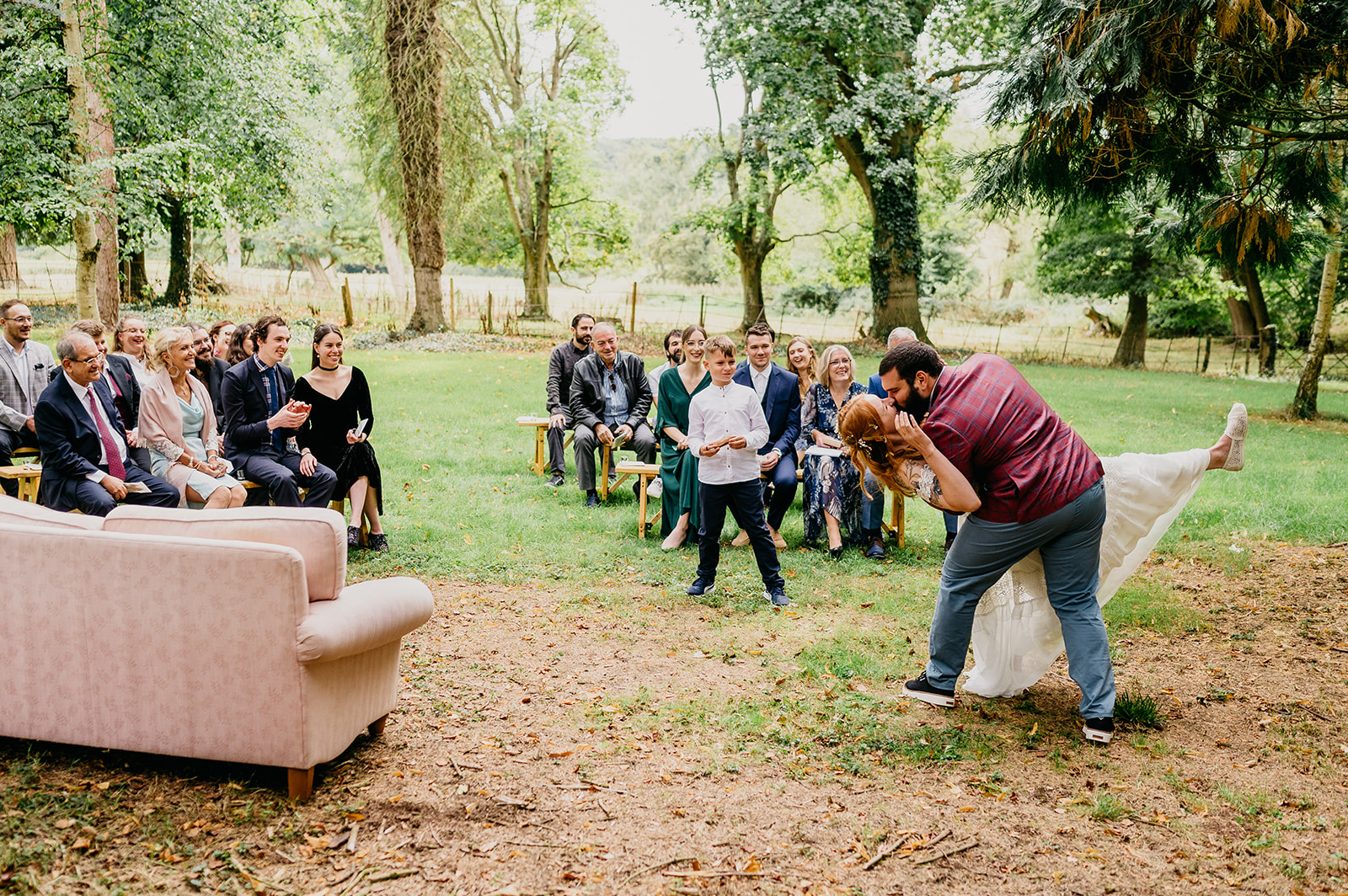 first kiss during humanist woodland wedding ceremony 
