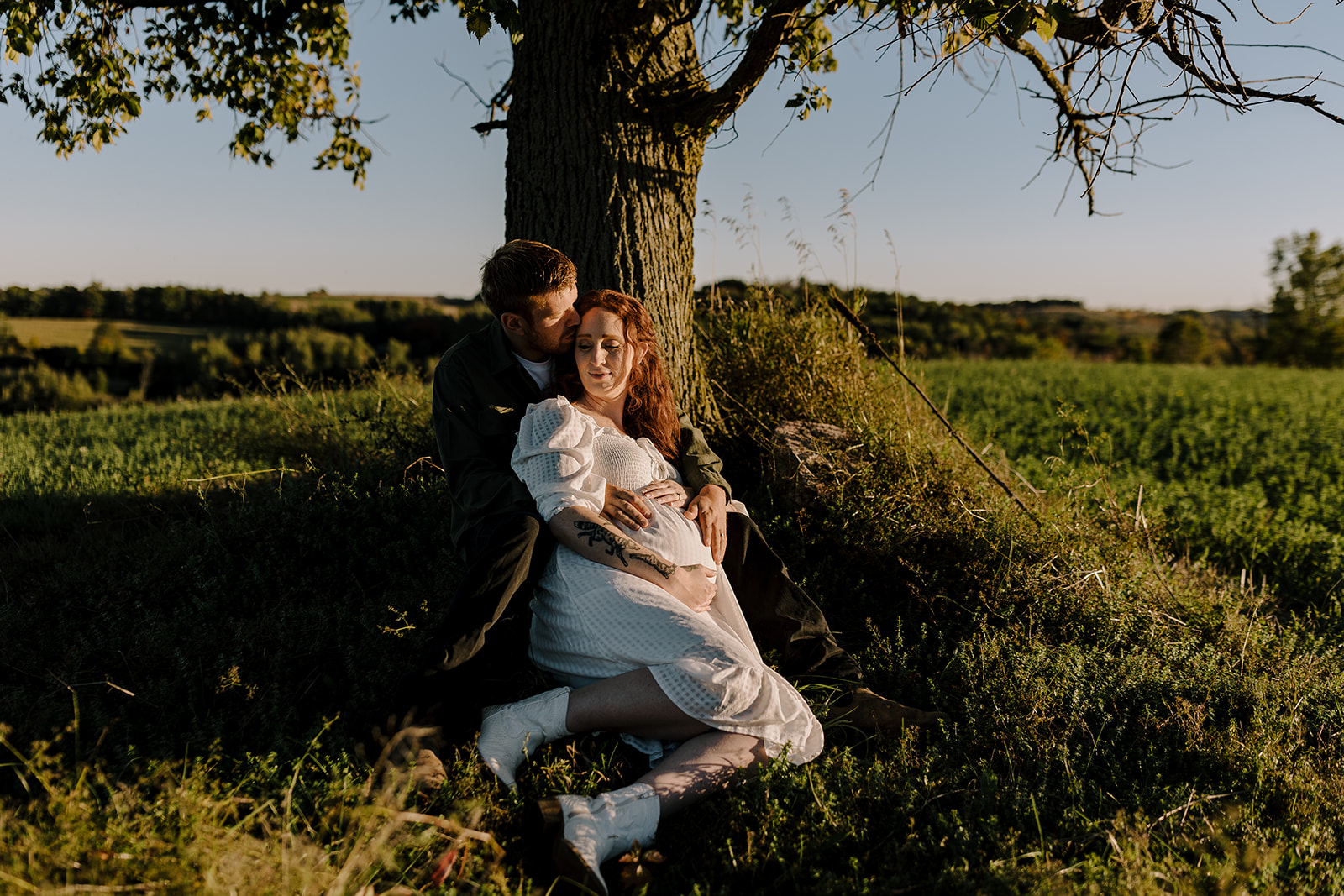 soon to be parents at farmhouse maternity session at sunset