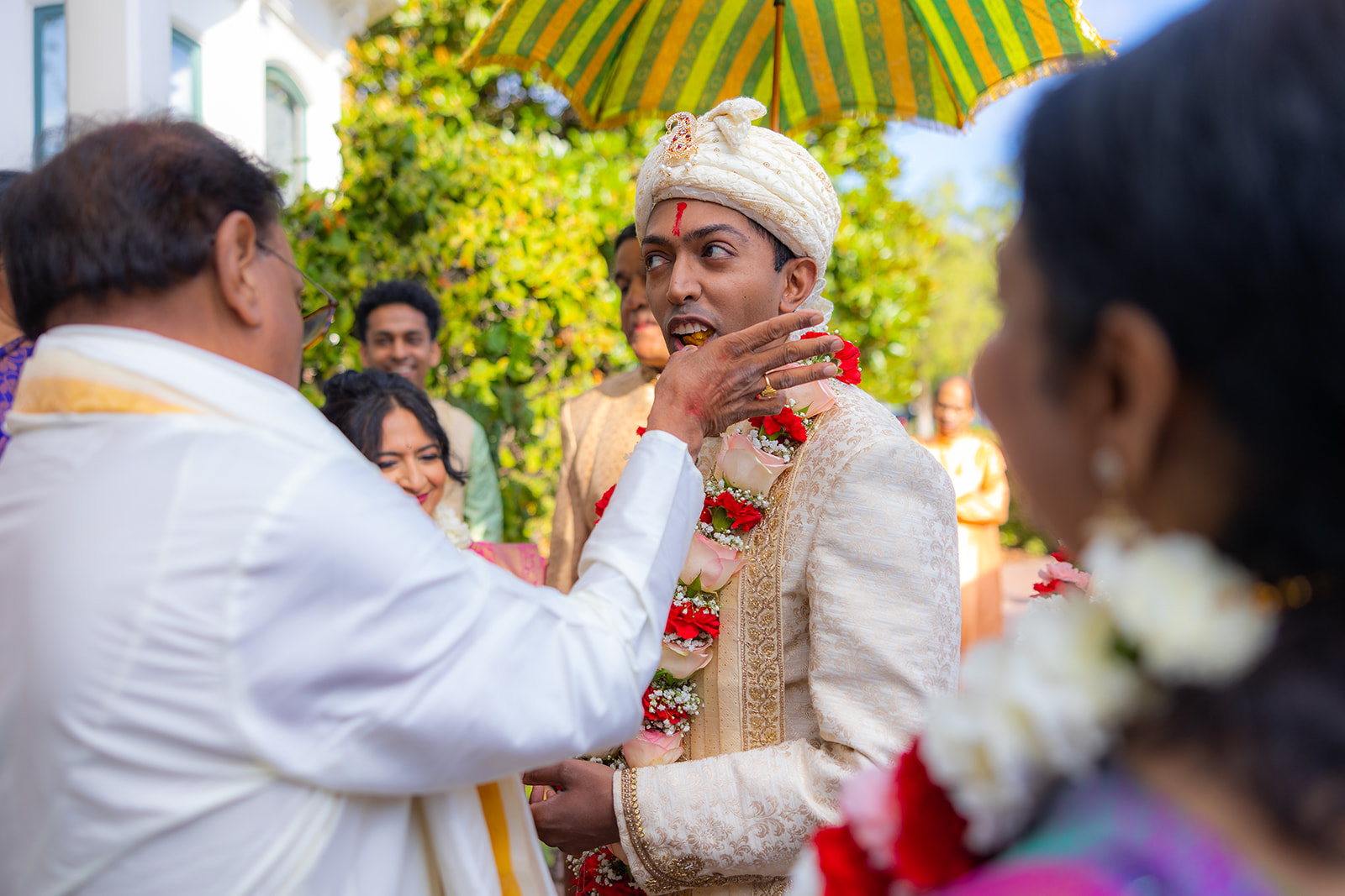 Groom eats fruit in the traditional way.