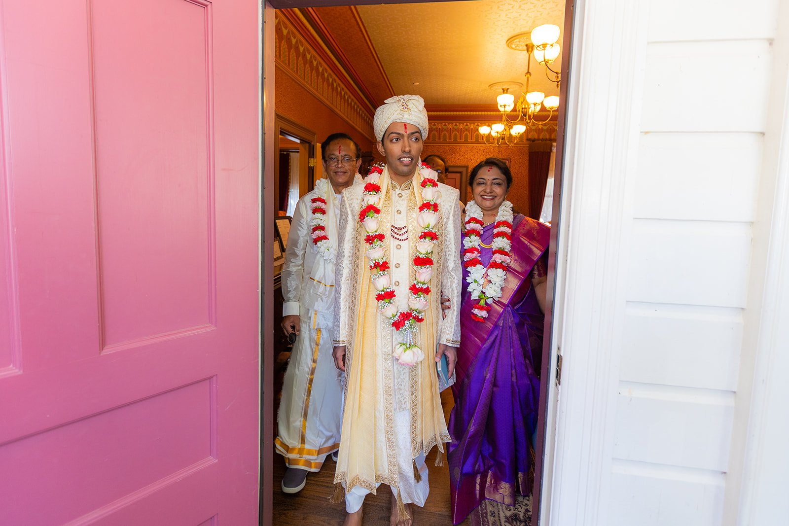 Groom opens door and leaves house ready for ceremony.