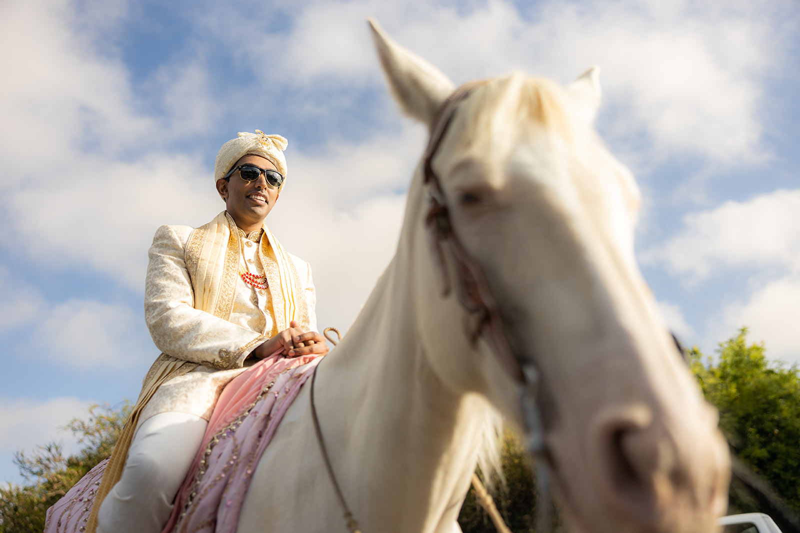 Groom rides on horse duirng indian wedding Barat in the bay area.