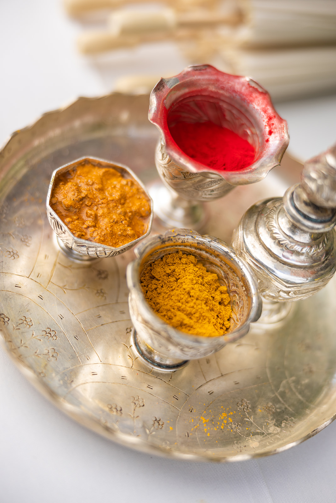 Indian spices at wedding ceremony on silver platter.