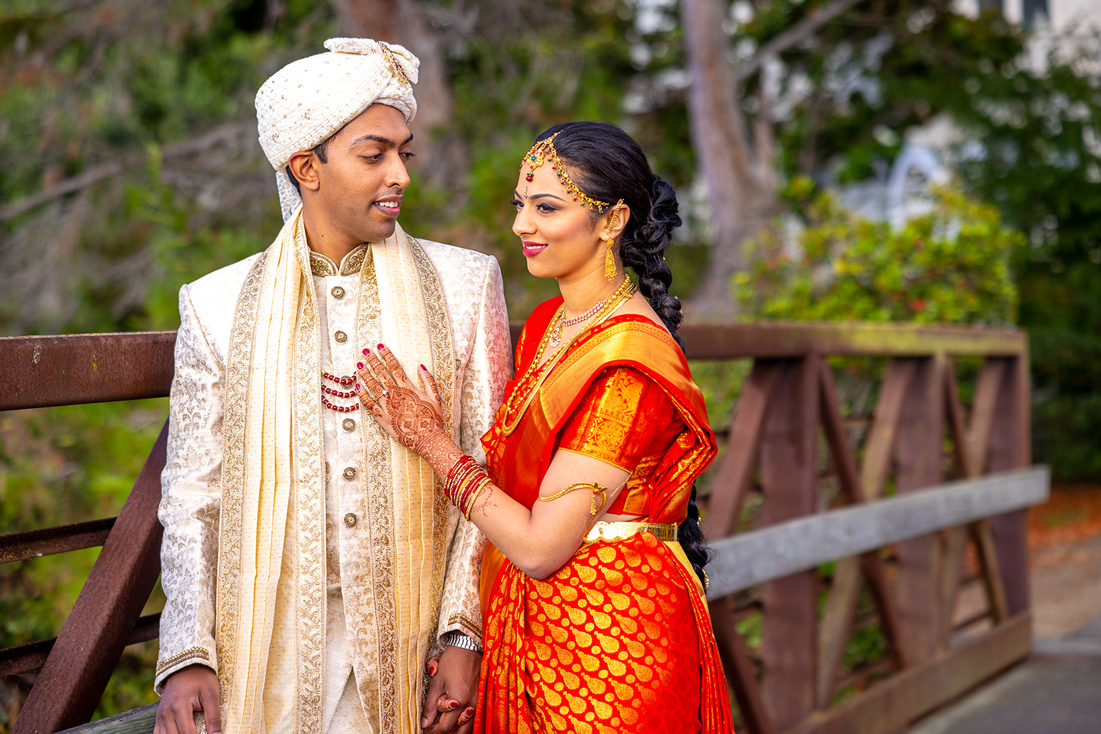 Indian wedding couple poses for a picture on a bridge right before their wedding in the bay area.