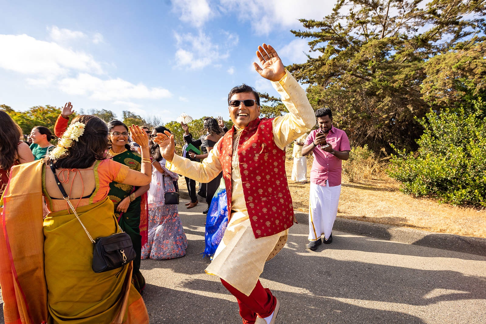 Indian wedding guests celebrate with dances outside during Barat.