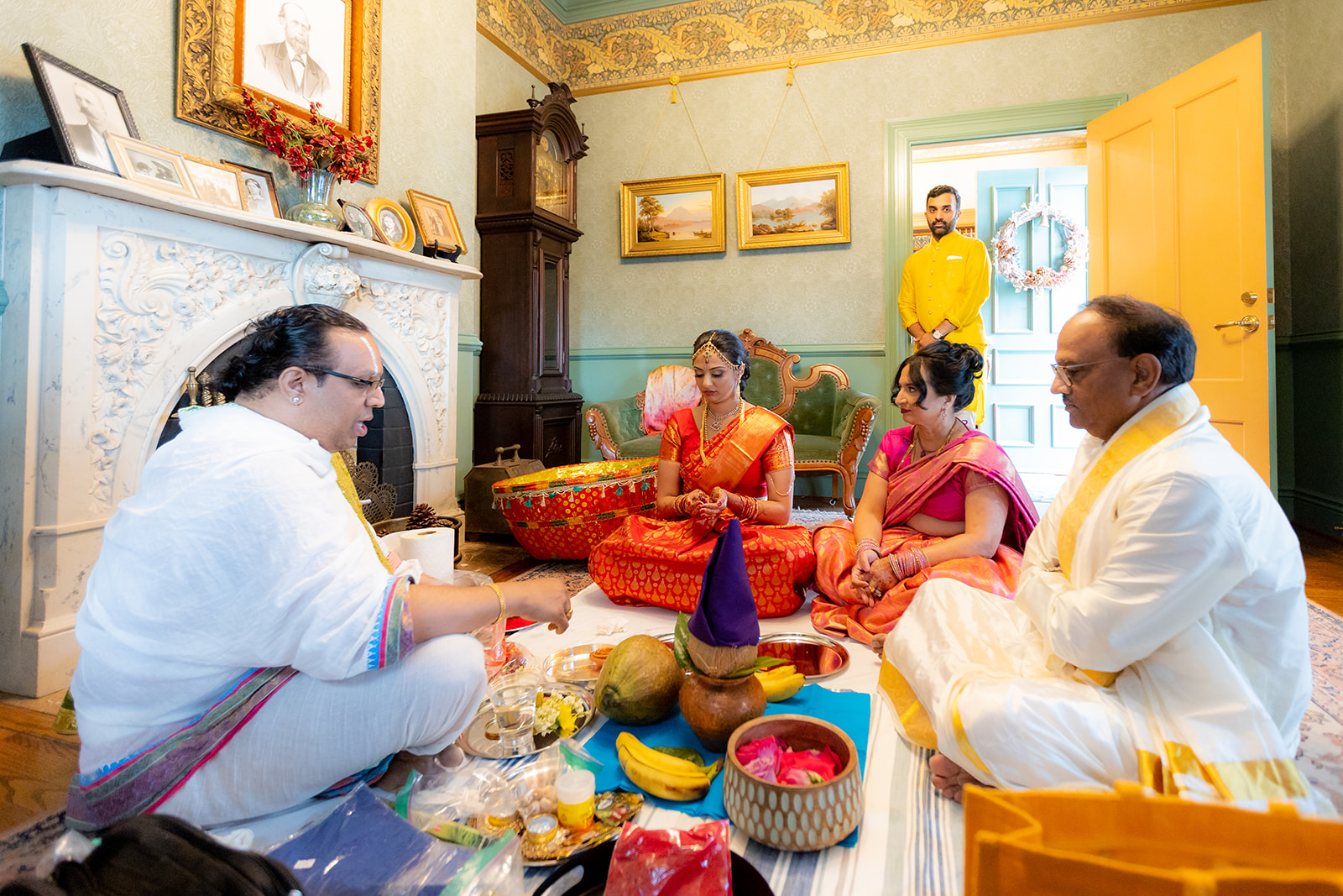 Pre-wedding ceremony with priest with brides family sitting doing traditional blessings.
