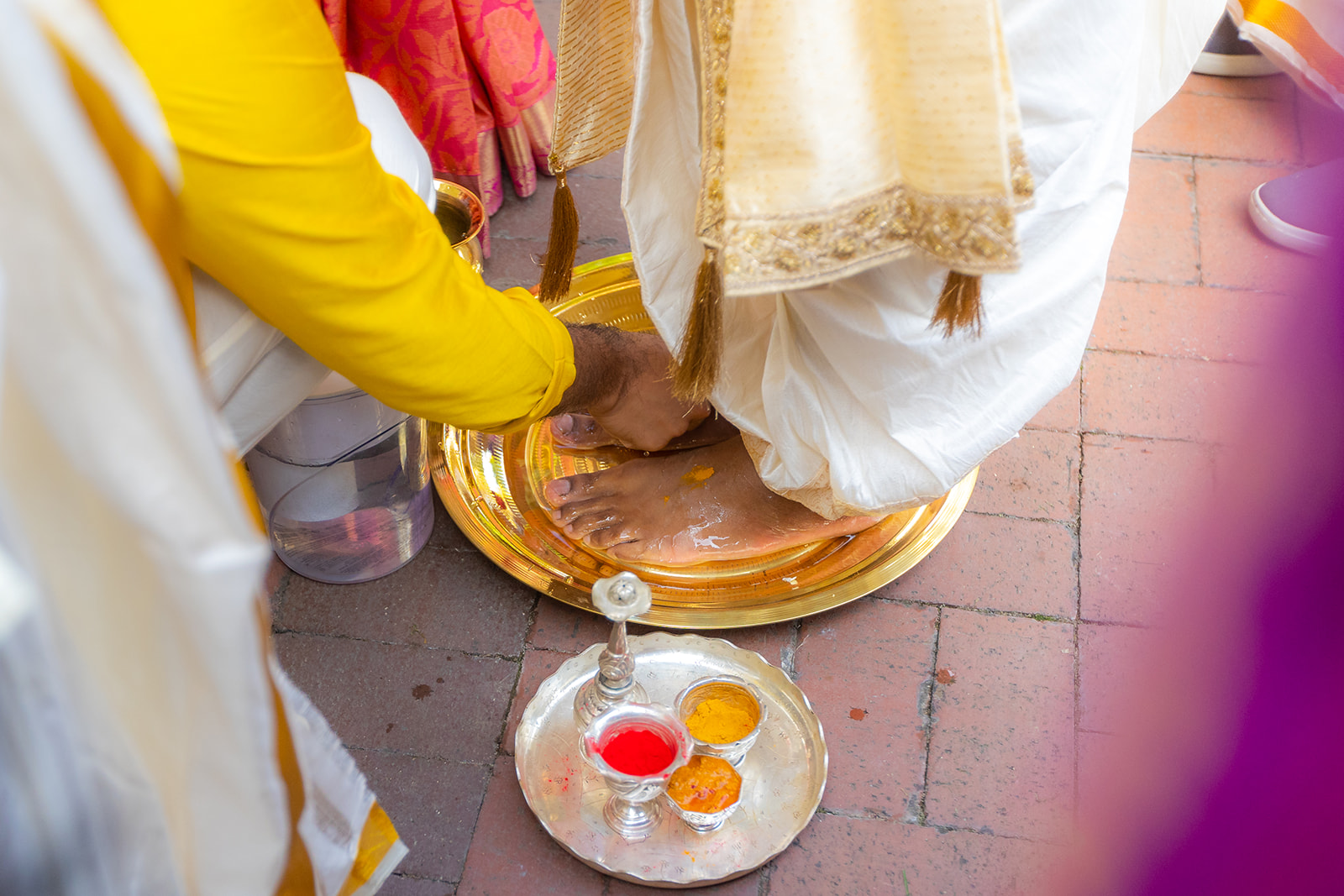 The groom's feet gets washed in the indian wedding tradition at Renstorff House, a Bay Area Indian Wedding Venue.