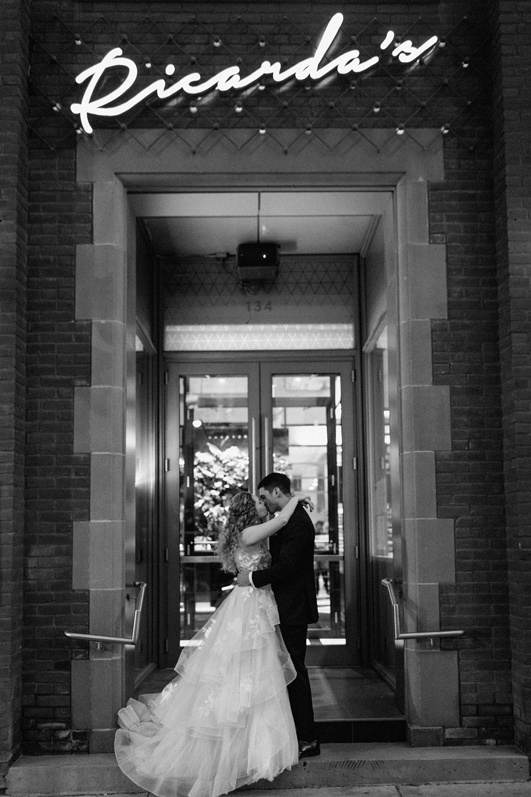 Couple kisses outside of Ricarda's Toronto on Wedding Day
