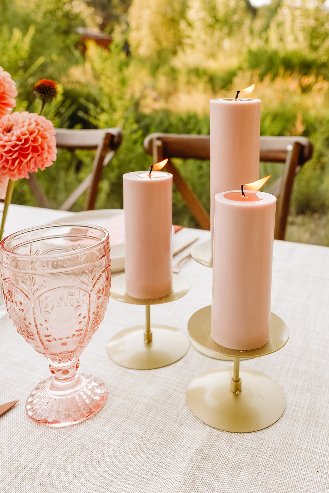 A vintage rose colored glass and pink candles for a reception table