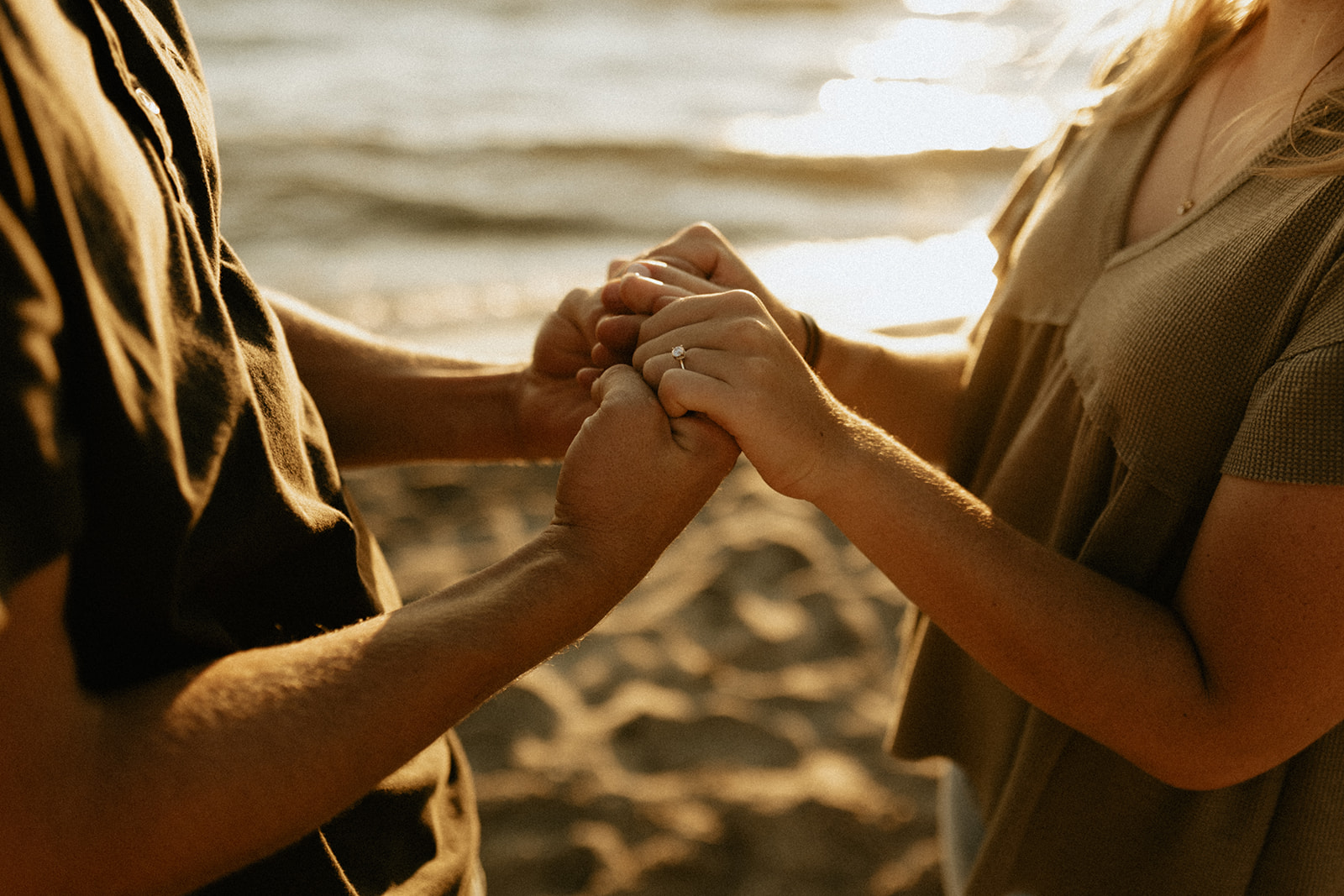 A couple holding hands at Saugatuck Dunes State Park in Michigan