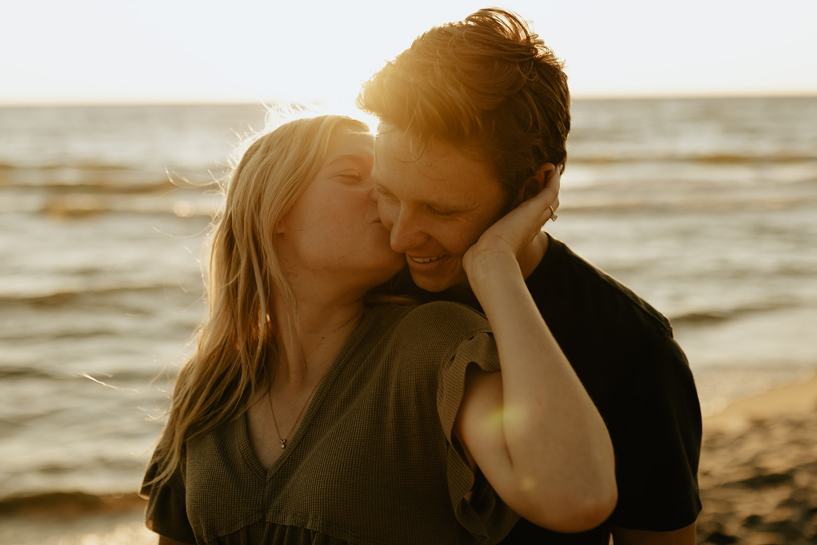 A couple kissing at Saugatuck Dunes State Park in Michigan 