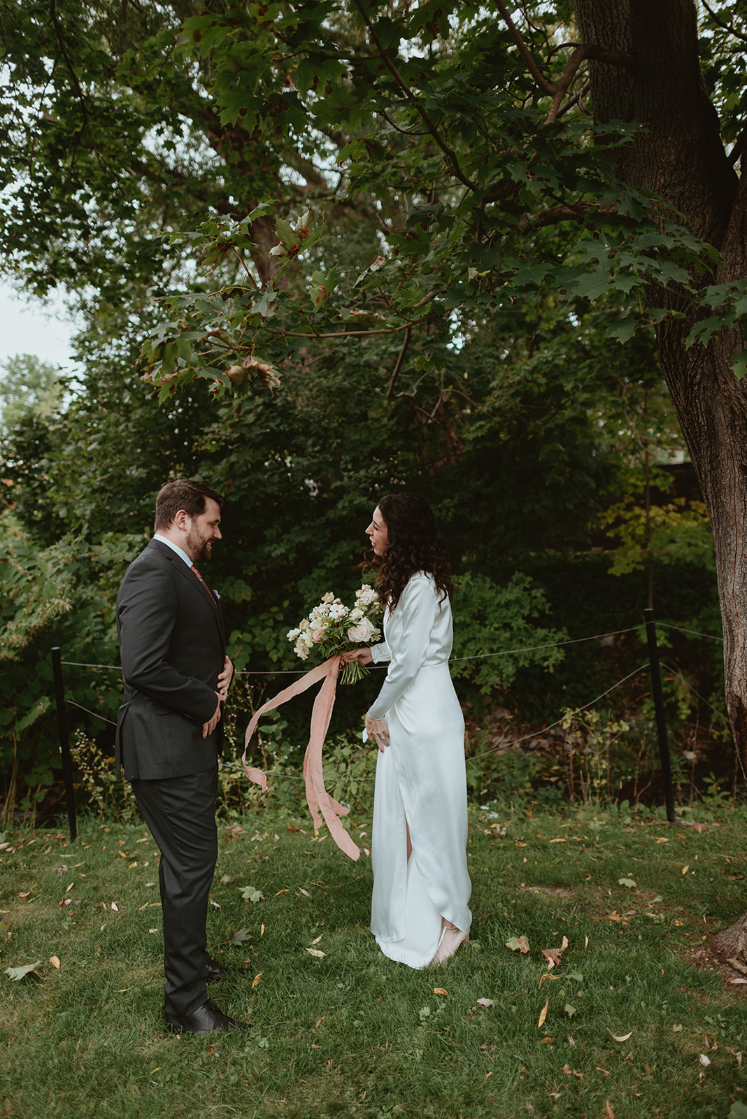 Fun bride and groom first look under the trees for an intimate fall wedding.