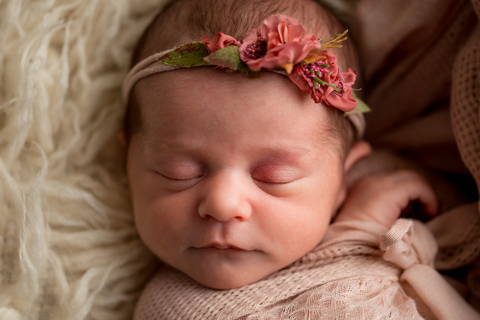 close up portrait of baby girl sleeping with floral headband