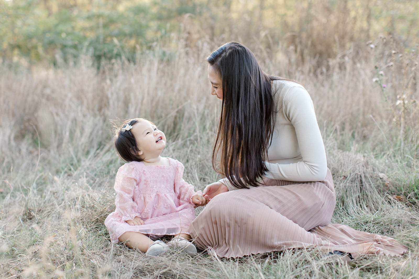 Mom and daughter look at each other with wonder during family photo session in Toronto, Ontario