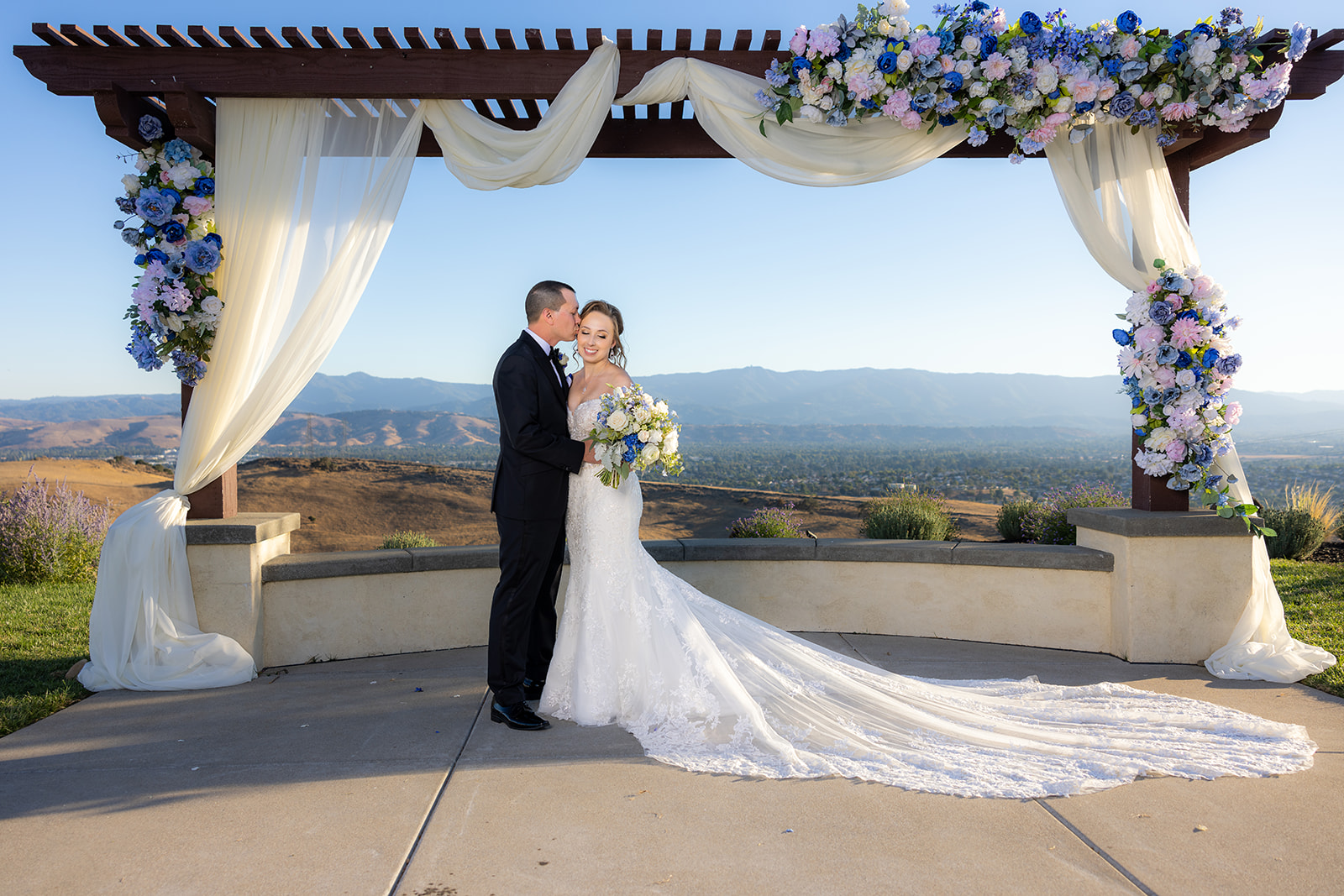 a couple at the alter posing for a kiss at the ranch at silver creek without a first look
