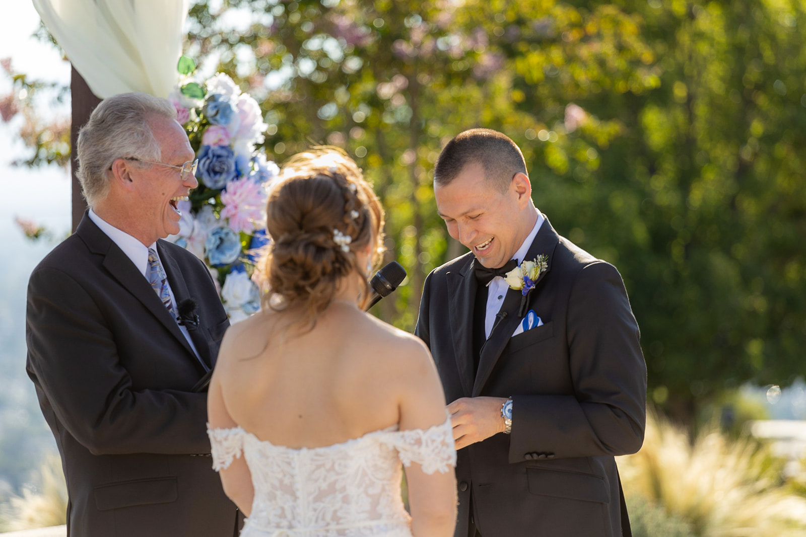 a groom, bride and officiant from officially yours standing at the alter without a first look